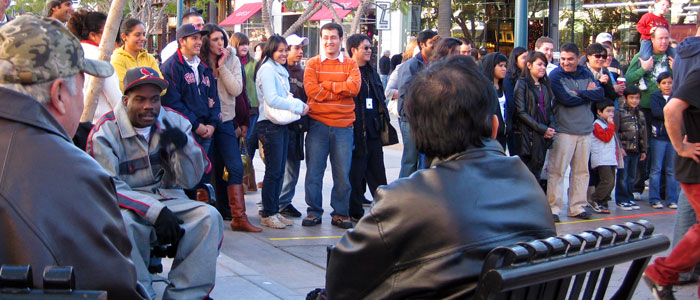 Gathering around performers at the Promenade